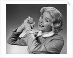 1950s 1960s Woman Making Winning Symbolic Hand Gesture With Raised Clasped Hands by Anonymous