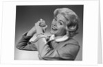 1950s 1960s Woman Making Winning Symbolic Hand Gesture With Raised Clasped Hands by Anonymous