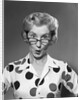 1950s 1960s Portrait Woman Polka Dot Dress Looking Over Eyeglasses by Anonymous