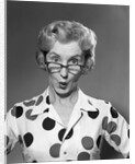 1950s 1960s Portrait Woman Polka Dot Dress Looking Over Eyeglasses by Anonymous