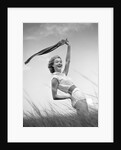1950s 1960s Young Woman Bending Back Holding Scarf In The Wind Standing On Grassy Beach Dune by Anonymous