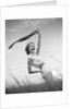 1950s 1960s Young Woman Bending Back Holding Scarf In The Wind Standing On Grassy Beach Dune by Anonymous
