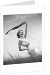 1950s 1960s Young Woman Bending Back Holding Scarf In The Wind Standing On Grassy Beach Dune by Anonymous