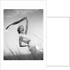 1950s 1960s Young Woman Bending Back Holding Scarf In The Wind Standing On Grassy Beach Dune by Anonymous