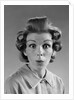 1960s Portrait Woman With Hair In Rollers Eyes Wide With Suprise by Anonymous