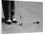 1950s Man Knees Down Putt On Golf Green by Anonymous