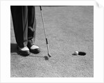 1950s Man Knees Down Putt On Golf Green by Anonymous