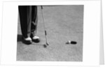 1950s Man Knees Down Putt On Golf Green by Anonymous