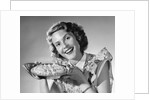 1950s Woman Presenting Holding Freshly Baked Pie by Anonymous