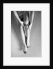 Woman's Hands Putting A Pair Of Sheer Stockings On Her Legs by Anonymous
