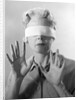 1960s Elderly Woman Wearing Blindfold Holding Up Her Hands by Anonymous