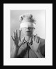 1960s Elderly Woman Wearing Blindfold Holding Up Her Hands by Anonymous
