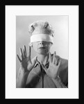 1960s Elderly Woman Wearing Blindfold Holding Up Her Hands by Anonymous