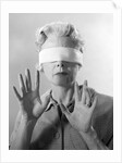 1960s Elderly Woman Wearing Blindfold Holding Up Her Hands by Anonymous