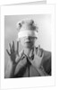 1960s Elderly Woman Wearing Blindfold Holding Up Her Hands by Anonymous