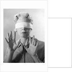 1960s Elderly Woman Wearing Blindfold Holding Up Her Hands by Anonymous