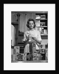 1960s Woman Housewife In Kitchen Checking Grocery Food Shopping List by Anonymous