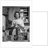 1960s Woman Housewife In Kitchen Checking Grocery Food Shopping List by Anonymous