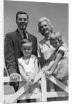 1950s 1960s Portrait Family Father Mother Son Daughter Behind White Fence Outdoor by Anonymous