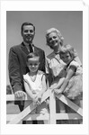 1950s 1960s Portrait Family Father Mother Son Daughter Behind White Fence Outdoor by Anonymous