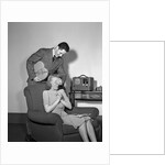 1940s Teen Couple Boy With Hand Over Girl Eyes Surprising Her With Box Of Valentines Day Candy by Anonymous