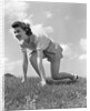 1940s Young Teen Woman Kneeling In Grass In Track Race Ready Starting Position by Anonymous