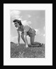 1940s Young Teen Woman Kneeling In Grass In Track Race Ready Starting Position by Anonymous