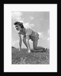 1940s Young Teen Woman Kneeling In Grass In Track Race Ready Starting Position by Anonymous