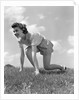 1940s Young Teen Woman Kneeling In Grass In Track Race Ready Starting Position by Anonymous