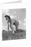 1940s Young Teen Woman Kneeling In Grass In Track Race Ready Starting Position by Anonymous