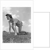 1940s Young Teen Woman Kneeling In Grass In Track Race Ready Starting Position by Anonymous