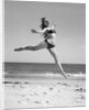 1950s Woman In Bikini Running And Jumping On The Beach Smiling by Anonymous