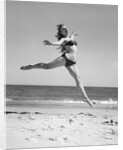 1950s Woman In Bikini Running And Jumping On The Beach Smiling by Anonymous