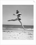 1950s Woman In Bikini Running And Jumping On The Beach Smiling by Anonymous