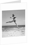 1950s Woman In Bikini Running And Jumping On The Beach Smiling by Anonymous