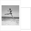 1950s Woman In Bikini Running And Jumping On The Beach Smiling by Anonymous