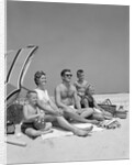 1960s Family Portrait Mother Father Daughter And Two Sons Sitting On Beach Under Umbrella by Anonymous