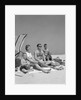 1960s Family Portrait Mother Father Daughter And Two Sons Sitting On Beach Under Umbrella by Anonymous