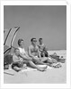 1960s Family Portrait Mother Father Daughter And Two Sons Sitting On Beach Under Umbrella by Anonymous