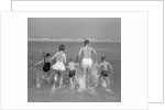 1960s Back View Of Family Of 5 Holding Hands Running Into Ocean by Anonymous