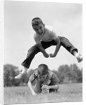 1960s Retro Boys Playing Leap Frog Outside Sky Grass Jump Jumping Crouching by Anonymous