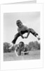 1960s Retro Boys Playing Leap Frog Outside Sky Grass Jump Jumping Crouching by Anonymous