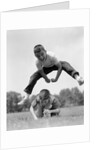 1960s Retro Boys Playing Leap Frog Outside Sky Grass Jump Jumping Crouching by Anonymous
