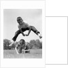 1960s Retro Boys Playing Leap Frog Outside Sky Grass Jump Jumping Crouching by Anonymous