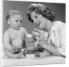 1960s Mother And Unhappy Baby Playing With Blocks by Anonymous