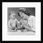 1960s Mother And Unhappy Baby Playing With Blocks by Anonymous