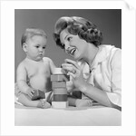 1960s Mother And Unhappy Baby Playing With Blocks by Anonymous