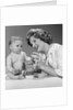 1960s Mother And Unhappy Baby Playing With Blocks by Anonymous