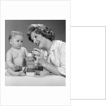 1960s Mother And Unhappy Baby Playing With Blocks by Anonymous