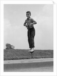 1960s Boy Jumping On Pogo Stick by Anonymous